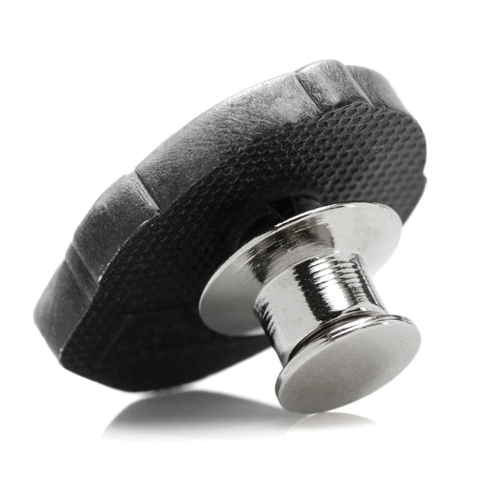Close up view of Mando helmet pin showing metallic texture and recessed details