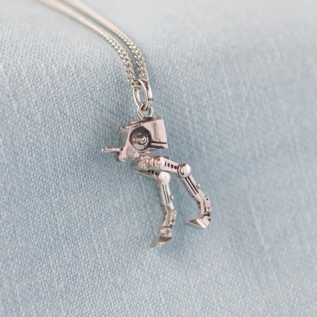 Side view showing the mechanical detail of the silver AT-ST necklace