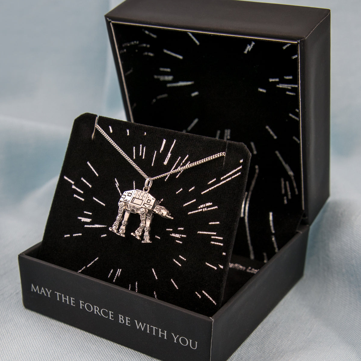 The AT-AT necklace displayed with the luxury travel pouch and collector packaging