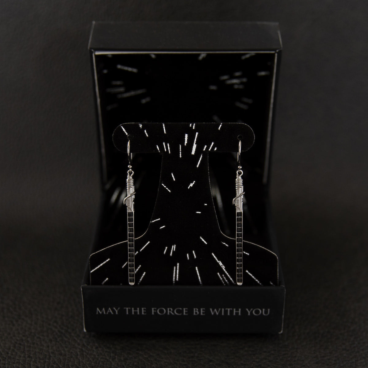 Lifestyle view showing the drop length of the Darksaber earrings.