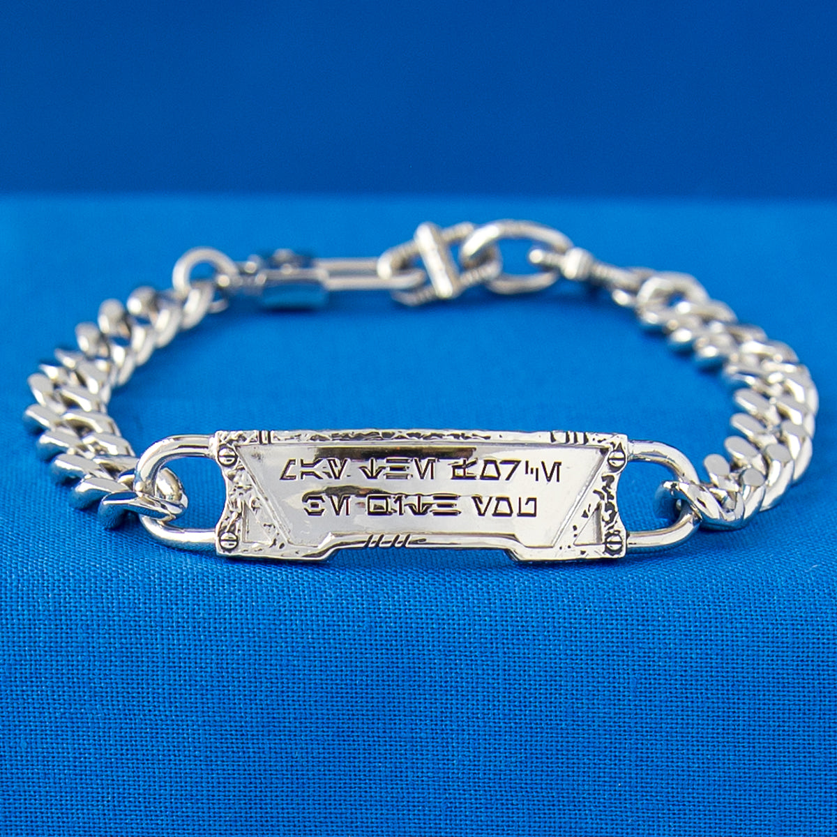 Side view showing the thickness and curve of the engraved nameplate.