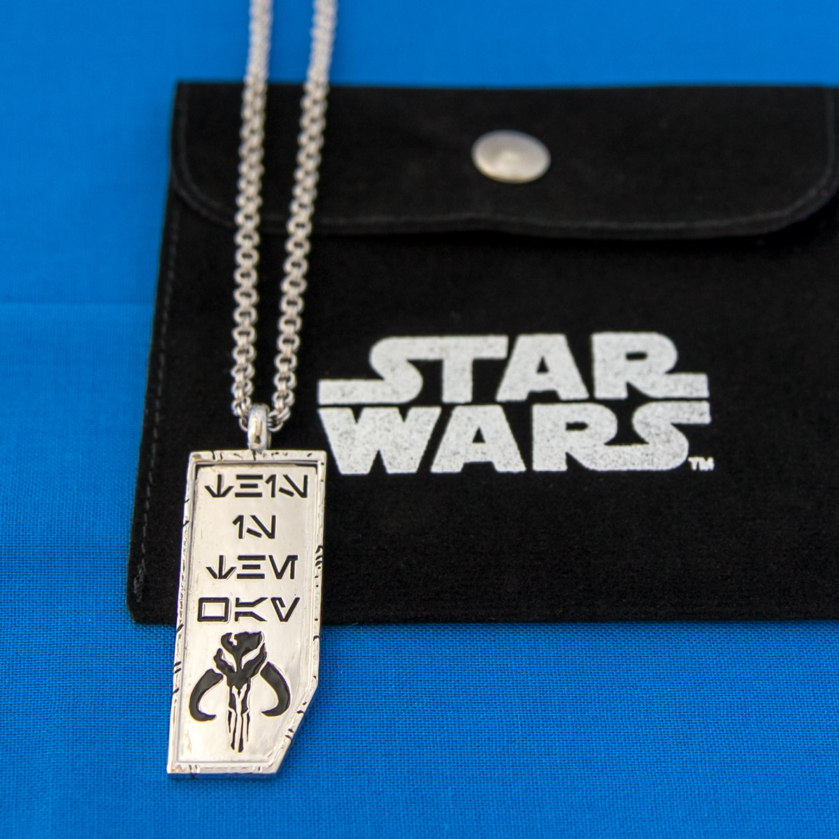Detailed view of the Aurebesh script on the Mandalorian Forge necklace
