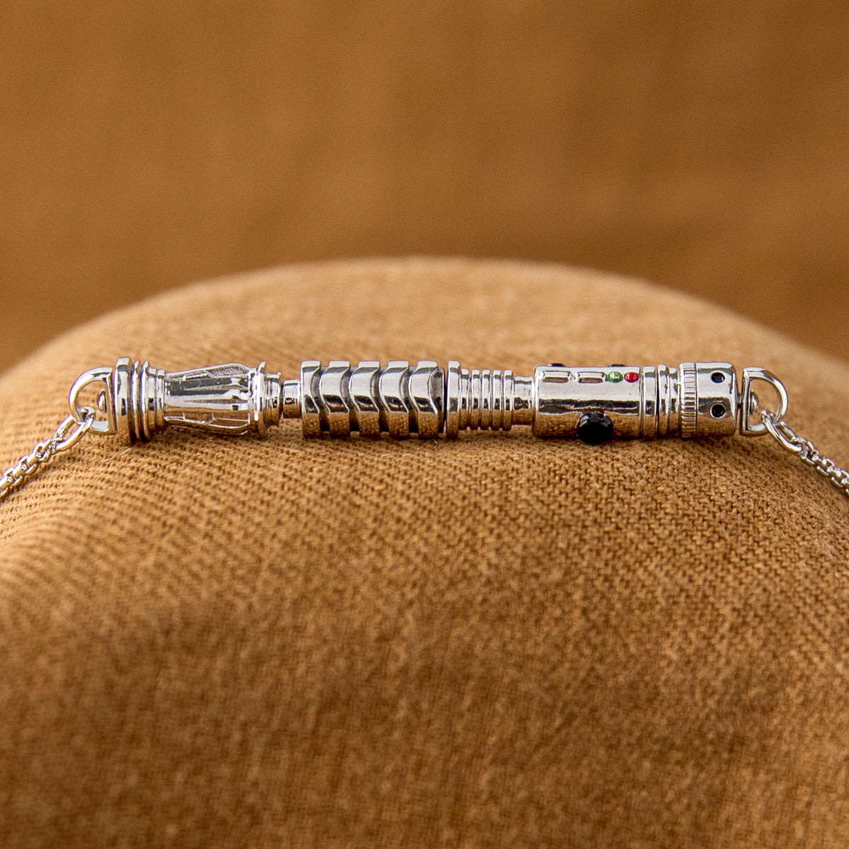A side-by-side view showing the interchangeable hilt components of the workshop necklace.