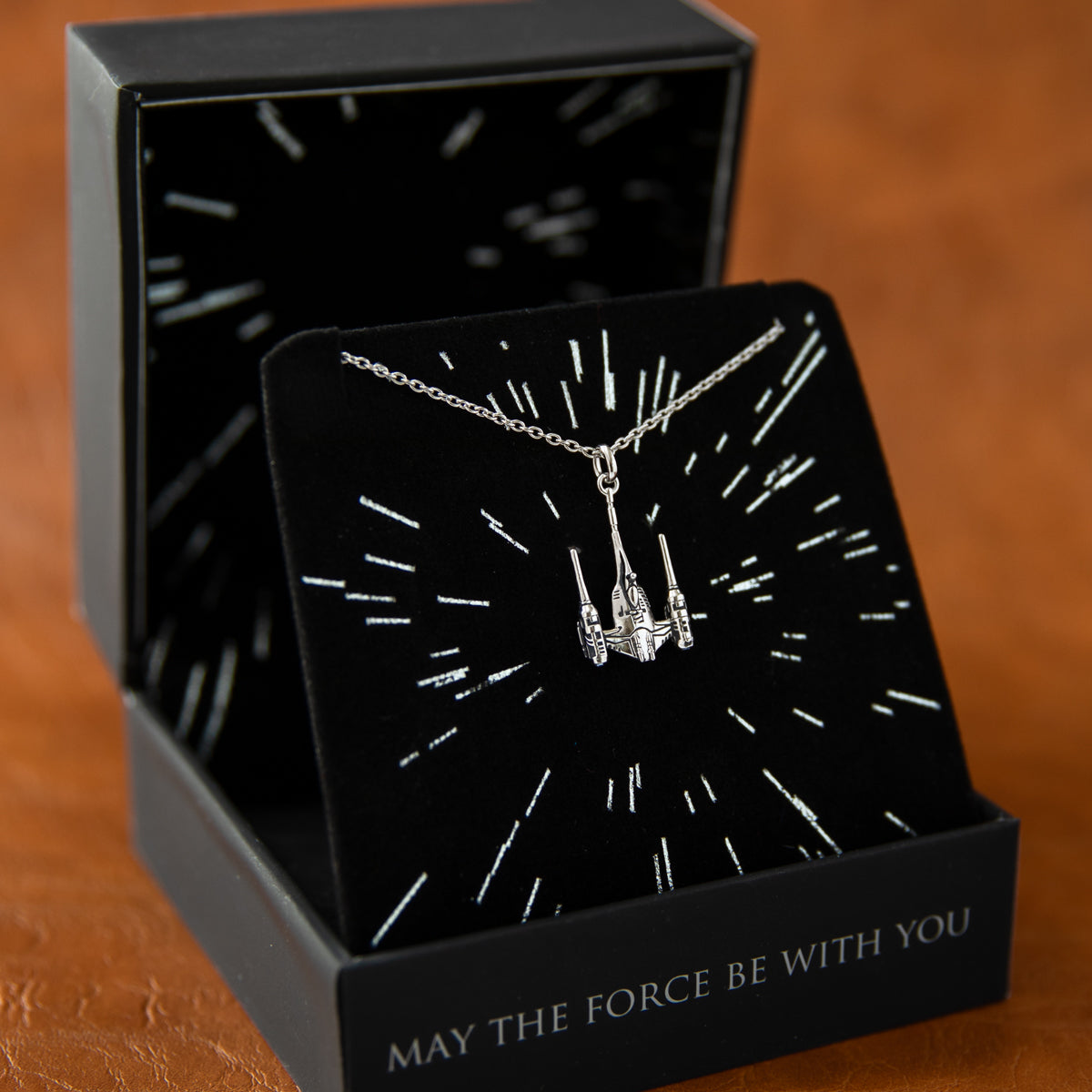 Frontal view of the Star Wars Naboo starship necklace.