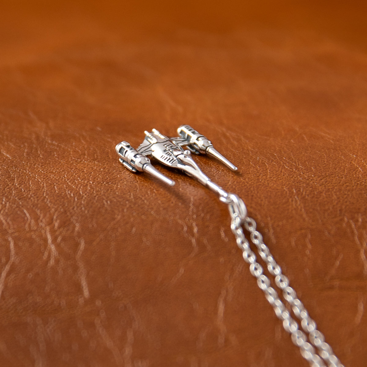 Detailed miniature sculpture of the Naboo N-1 Starfighter in antiqued sterling silver.