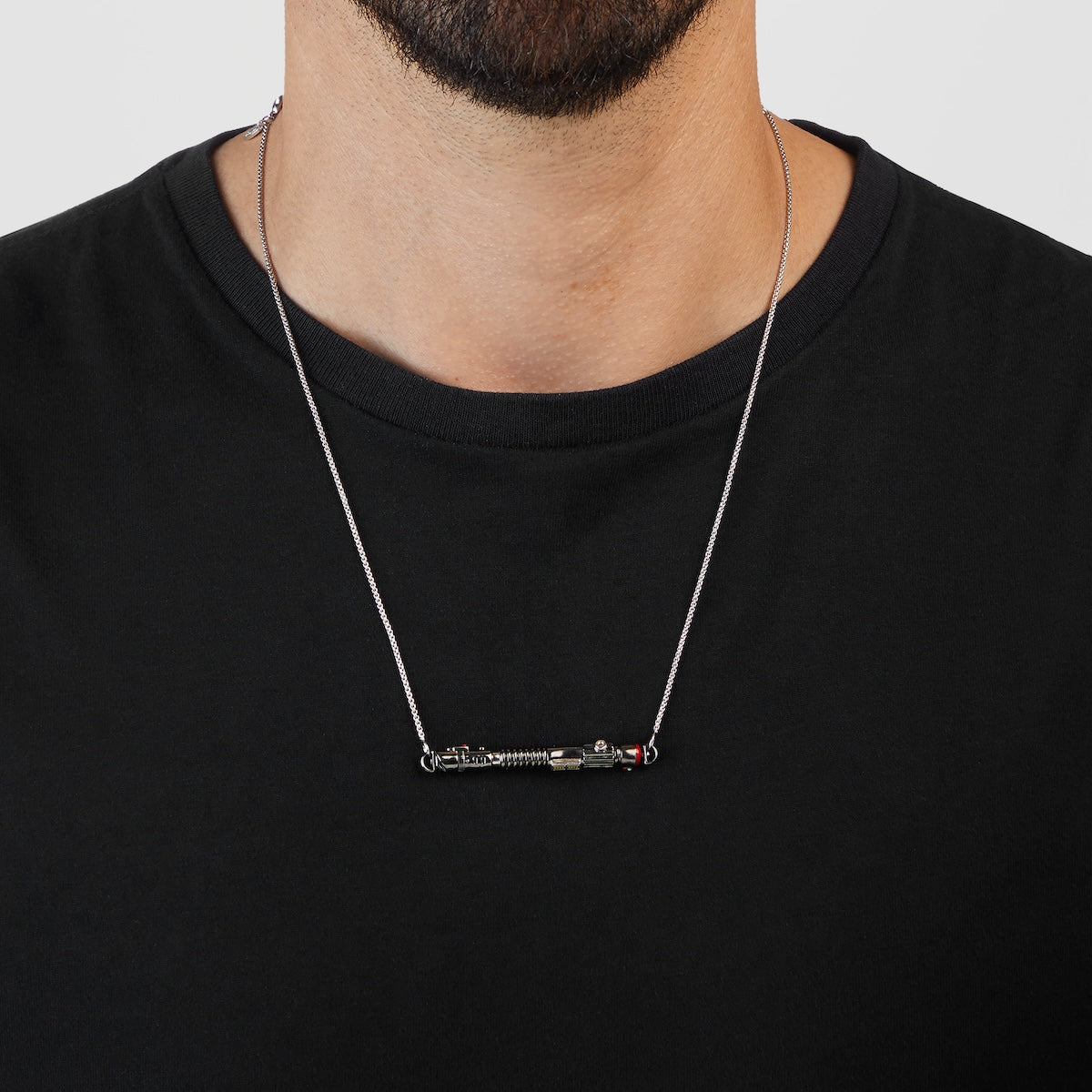 Close-up of the black rhodium and enamel finish on the lightsaber pendant.
